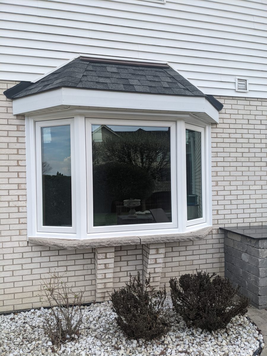 White bay window replacement on brick home